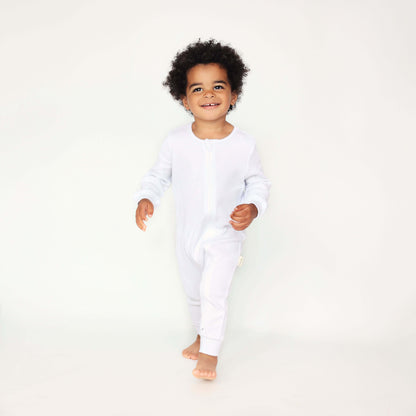 Elegant white baby sleepsuit by DreamBuy, showcasing luxurious ribbed cotton fabric, perfect as a thoughtful gift for modern parents.