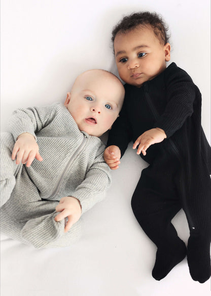 Stylish DreamBuy black zip-up sleepsuit for toddlers designed for comfort and active play, suitable for 6-12 months.