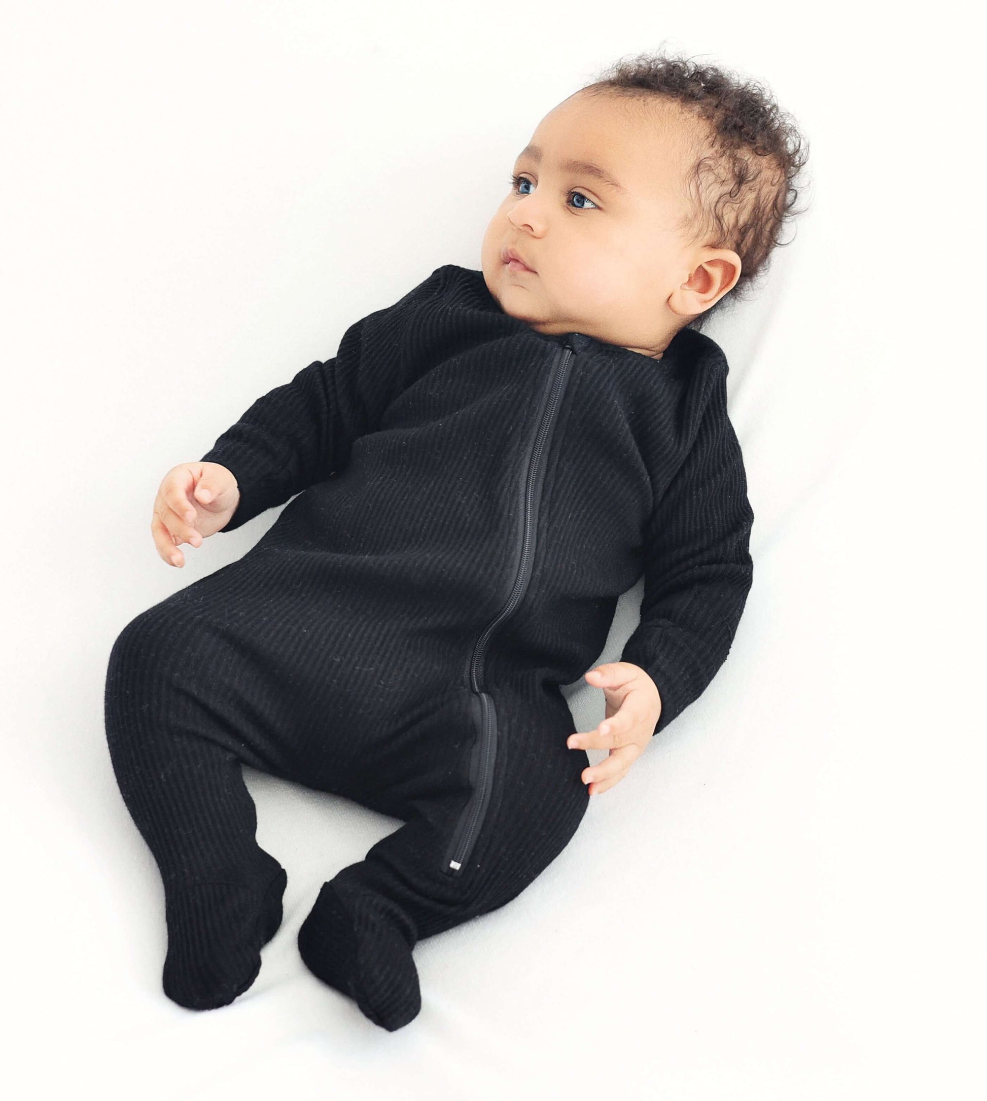 Close-up of DreamBuy luxury black baby sleepsuit showing high-quality fabric and secure zip closure for easy dressing.