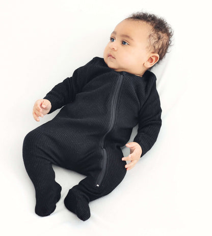 Close-up of DreamBuy luxury black baby sleepsuit showing high-quality fabric and secure zip closure for easy dressing.