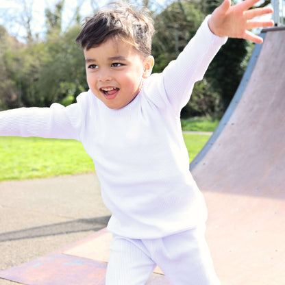 Elegant image of DreamBuy's luxury white PJs, highlighting the breathable 95% cotton fabric, offering comfort for the whole family.