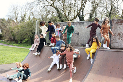 Elegant family portrait in DreamBuy luxury Velvet Mocha pyjamas, highlighting the ease and comfort for play or relaxation.