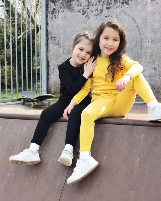 Luxury black matching family pajamas from DreamBuy, crafted from soft, breathable cotton, perfect for all ages from newborn to adult XXL, featuring comfort and style for cozy family nights.