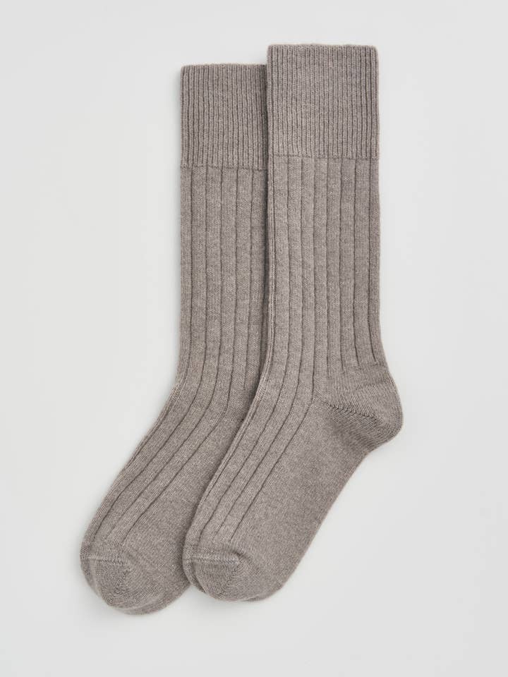 Luxury Merino bed socks in a chic setting, highlighting their temperature-regulating technology for ultimate comfort and warmth.