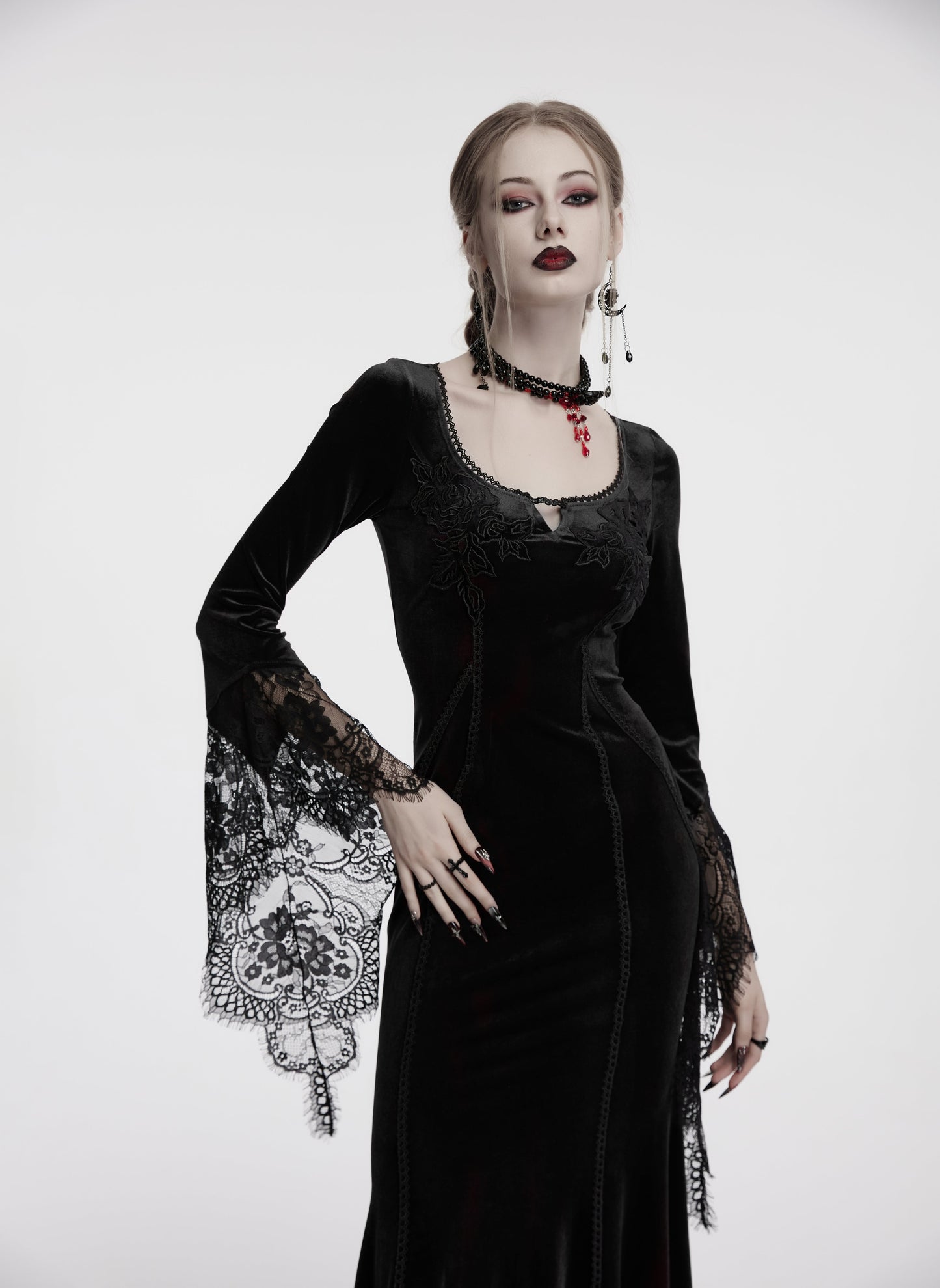 Elegant black velvet dress with lace sleeves and rose detail, perfect for gothic and alternative fashion.