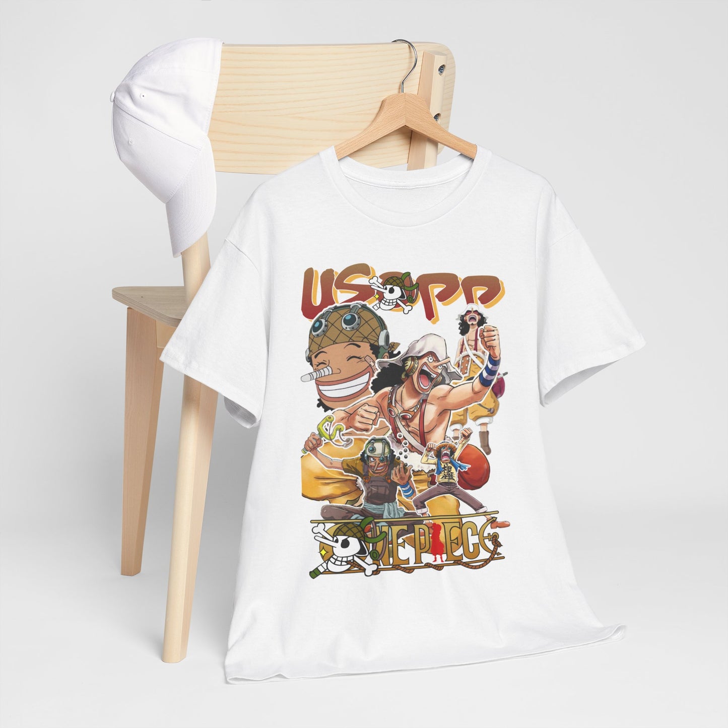 Chic composition of an Anime Manga T-shirt with vibrant Usopp graphic, elegantly arranged on a hanger beside a cap, symbolising casual elegance.