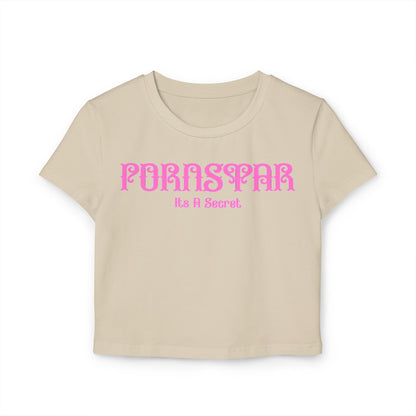 Chic beige cropped t-shirt displaying the fun text 'Pornstar It's A Secret' in a vibrant pink vintage style font, designed for comfort and casual elegance.