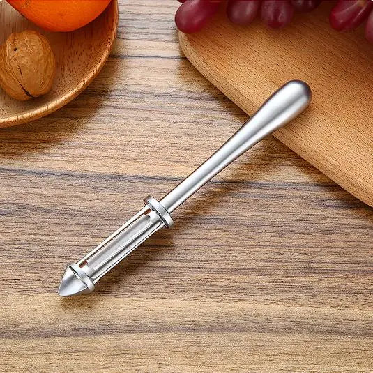 Chic multi-functional vegetable and fruit peeler in a modern kitchen setting, surrounded by fresh fruits, embodying luxury and functionality for refined cooking experiences.
