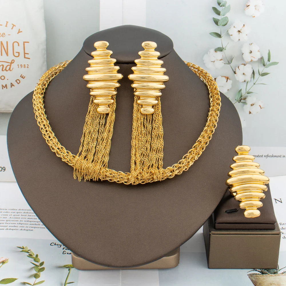 Luxury African fashion jewelry set for women featuring gold tassel earrings, elegant necklace, and stylish ring.