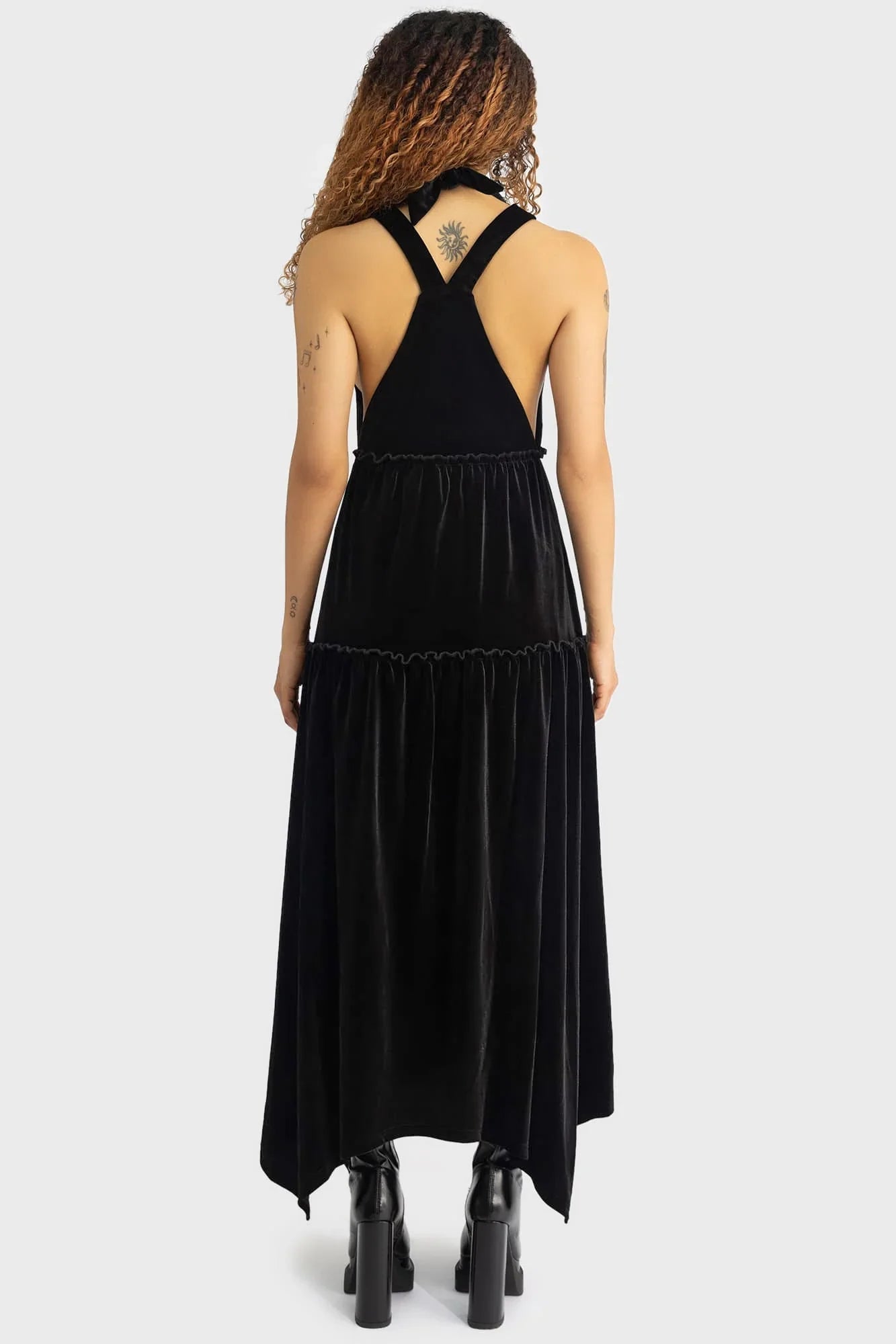 Flowing tiered design of the Killstar Ascended Velvet Maxi Pinafore Dress, showcasing its relaxed fit and celestial vibe, ideal for unique layering.
