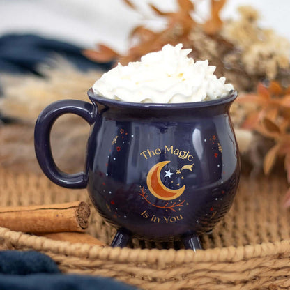 Charming midnight-blue cauldron mug with exquisite gold detailing of stars and crescent moon, perfect for those who cherish the mystical.