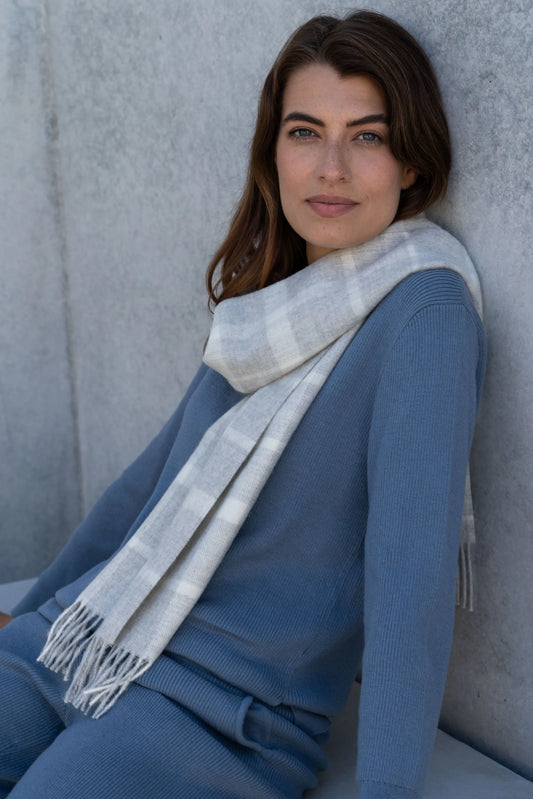 Luxury undyed alpaca plaid scarf featuring a soft brushed texture and elegant twisted fringes, showcasing natural fibres.