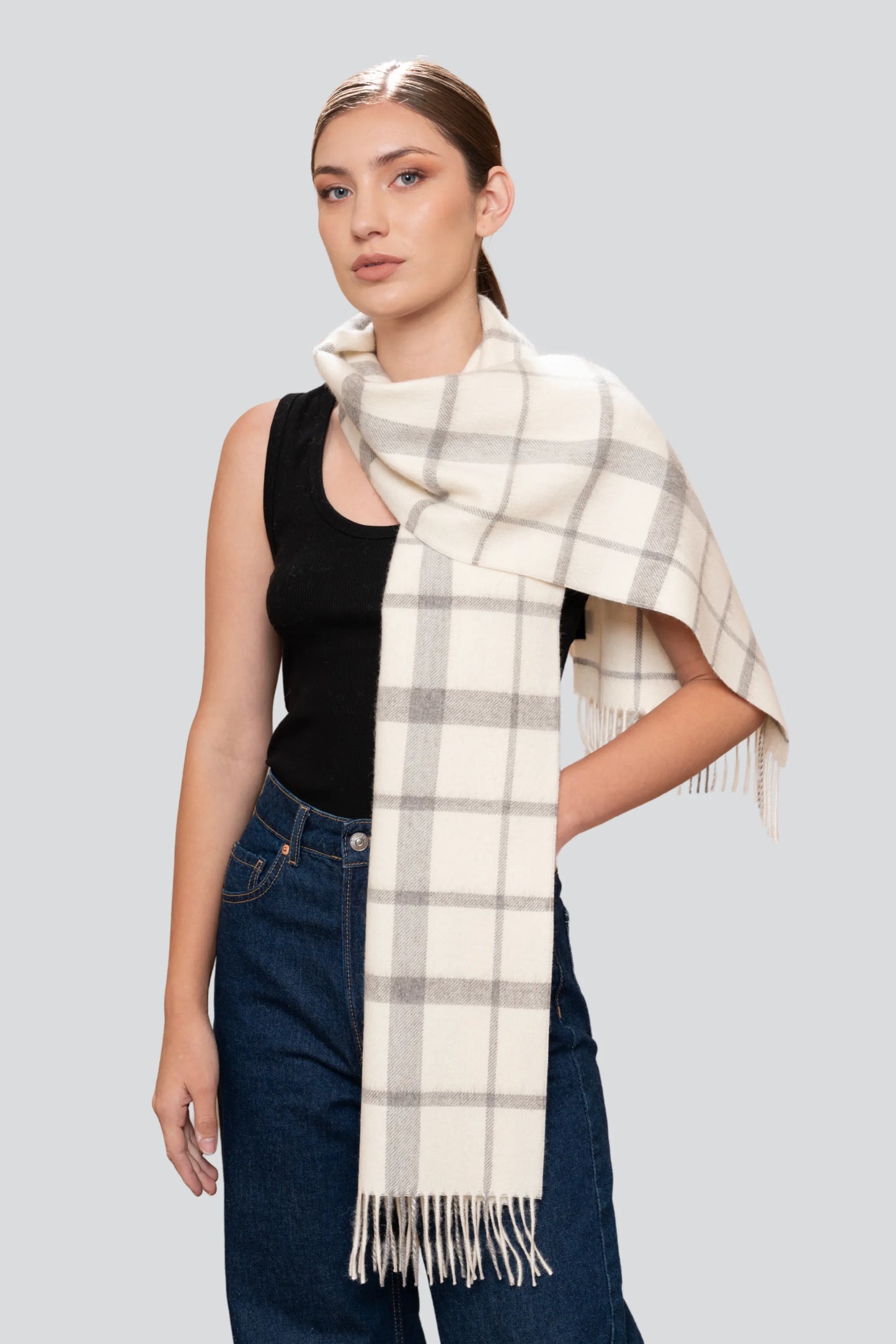 Luxury undyed alpaca plaid scarf in natural hues, showcasing a soft brushed texture and twisted fringes, perfect for elegant winter styling.