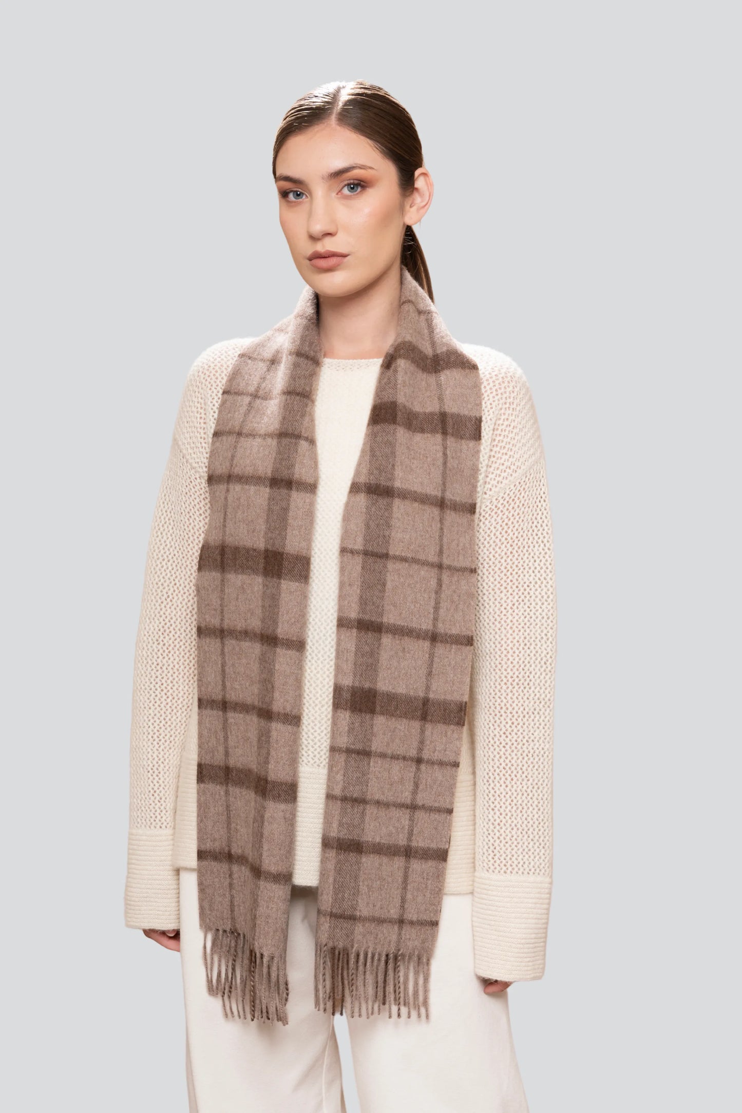 Soft alpaca scarf featuring timeless plaid design, ideal for winter styling and effortless sophistication.