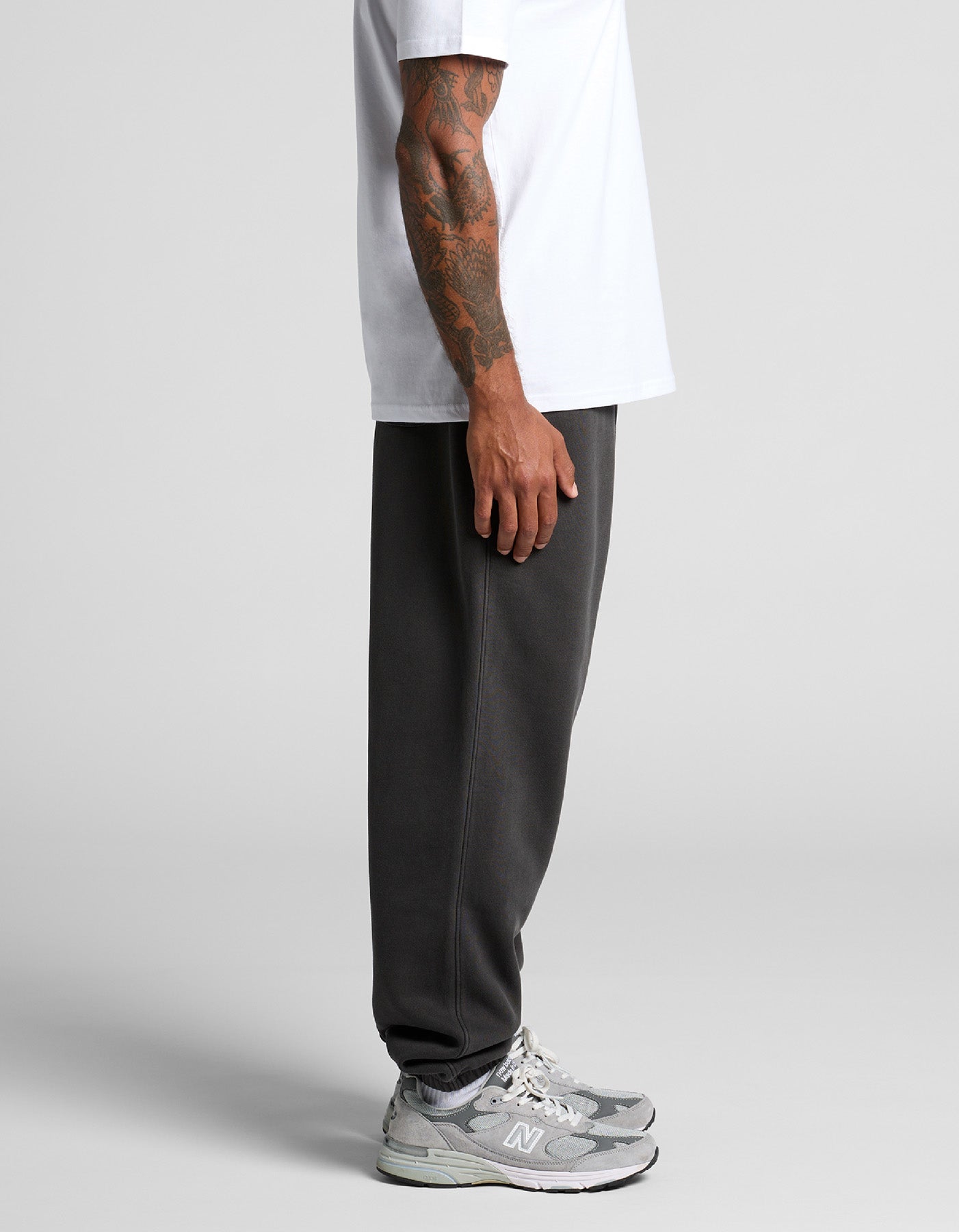 Lifestyle image of an individual wearing Anchor and Rose Apparel's Faded Relaxed Script Joggers, emphasizing their stylish fit and eco-friendly materials.