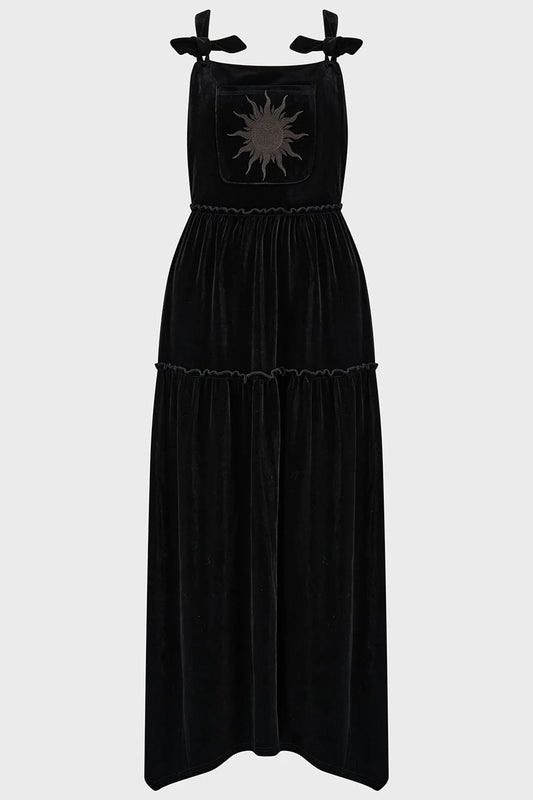 Close-up view of the black velvet fabric and intricate sun embroidery on the front pocket of the Killstar Ascended Velvet Maxi Pinafore Dress, exuding a mystical and elegant vibe.
