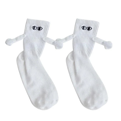 Chic display of white Novelty Romantic Magnetic Holding Hands Couple Socks, designed with eyes and arms, symbolizing connection and affection for couples.