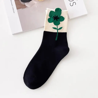 Luxurious Women's Tie-Dye Middle Tube Socks designed in elegant black with a green flower design, offering a chic and playful touch.