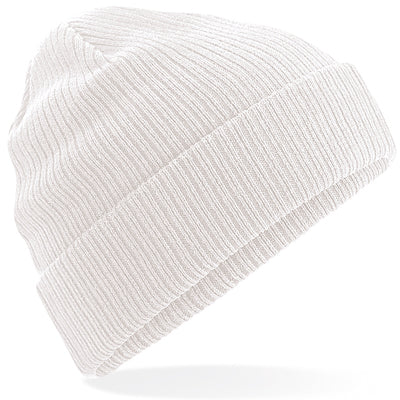 Model wearing a luxury organic cotton beanie, demonstrating its lightweight and breathable features in a chic outdoor setting.