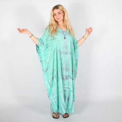 Luxury full-length tie dye kaftan dress in deep navy blue and fresh mint green, featuring dramatic sunburst design, perfect elegant beach cover-up and versatile summer outfit for UK sizes 8-16.