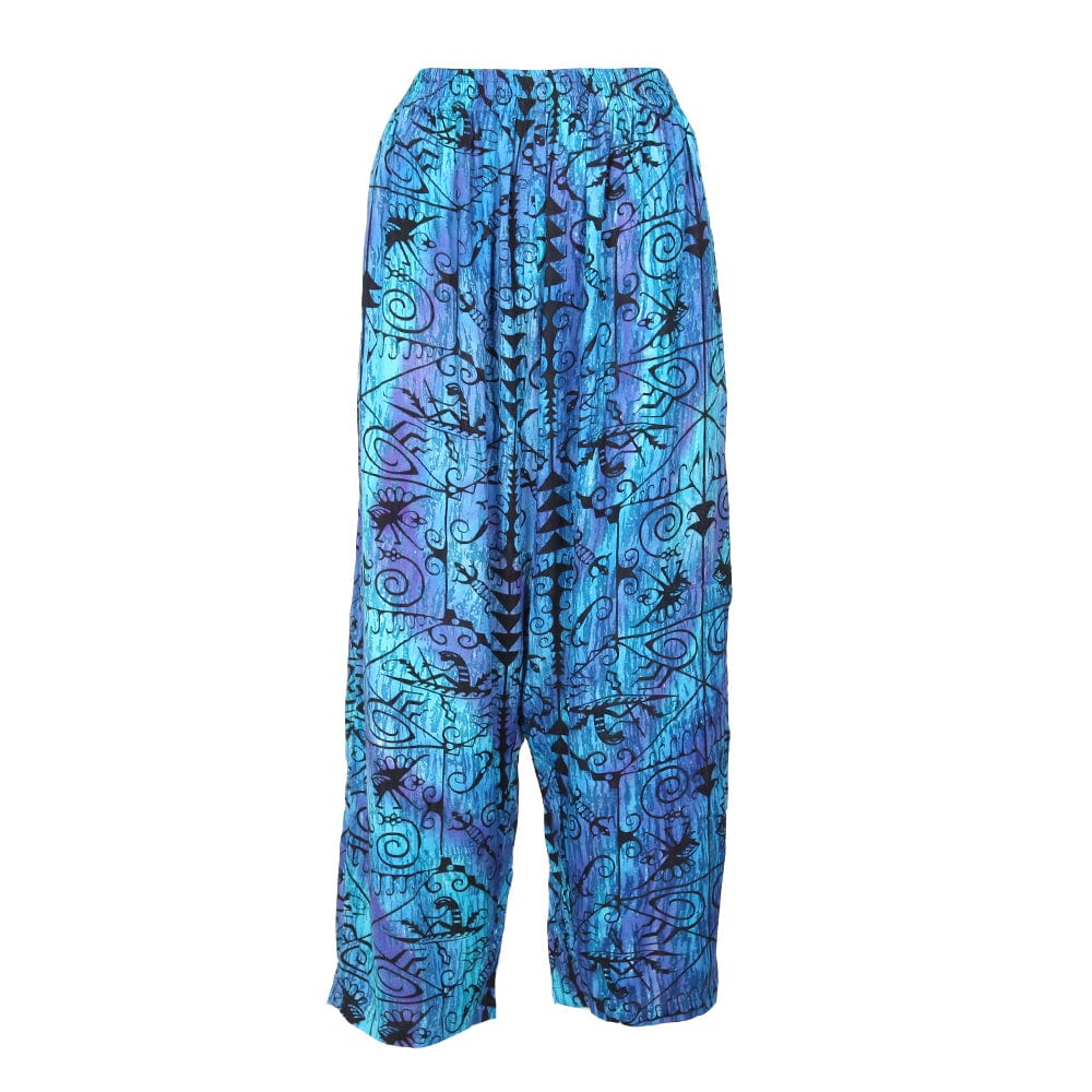 Luxe abstract lizard print trousers in rich blue and purple, featuring a quirky animal pattern, perfect for festivals, stylishly displayed on a model.