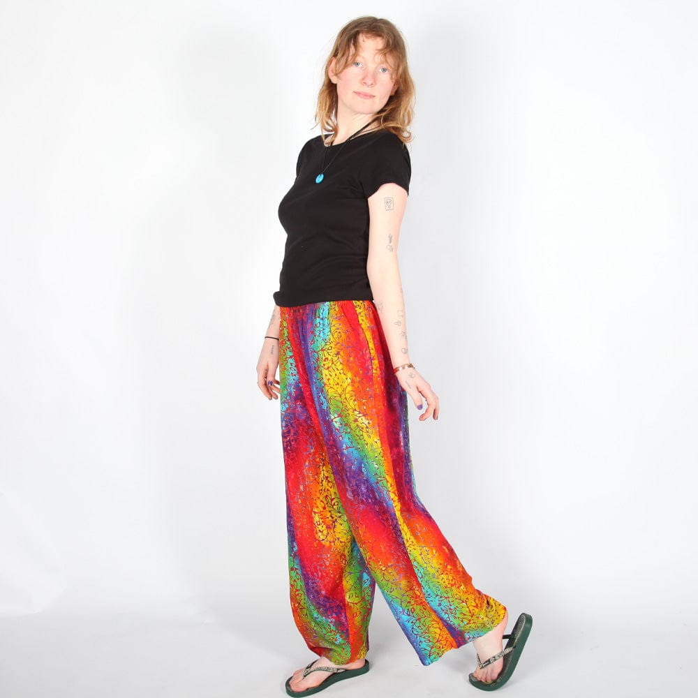 Full view of luxurious rainbow swirl batik trousers highlighting the straight leg silhouette and unique patterns, crafted for comfort and elegance in any setting.