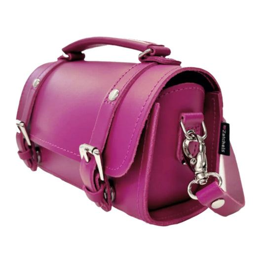 Close-up of Zatchels Bowler Bag, highlighting the artisanal craftsmanship and premium leather texture in striking magenta.