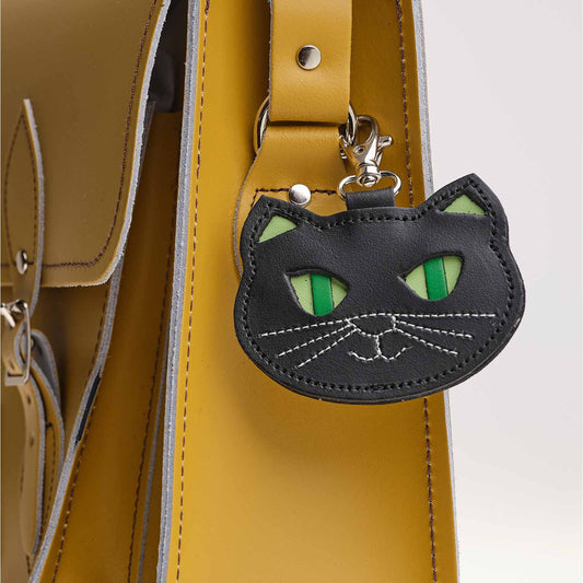 Luxury hand-crafted leather black cat bag charm, measuring 9 x 7.5cm, expertly made in England, showcasing fine craftsmanship and a distinctive design.