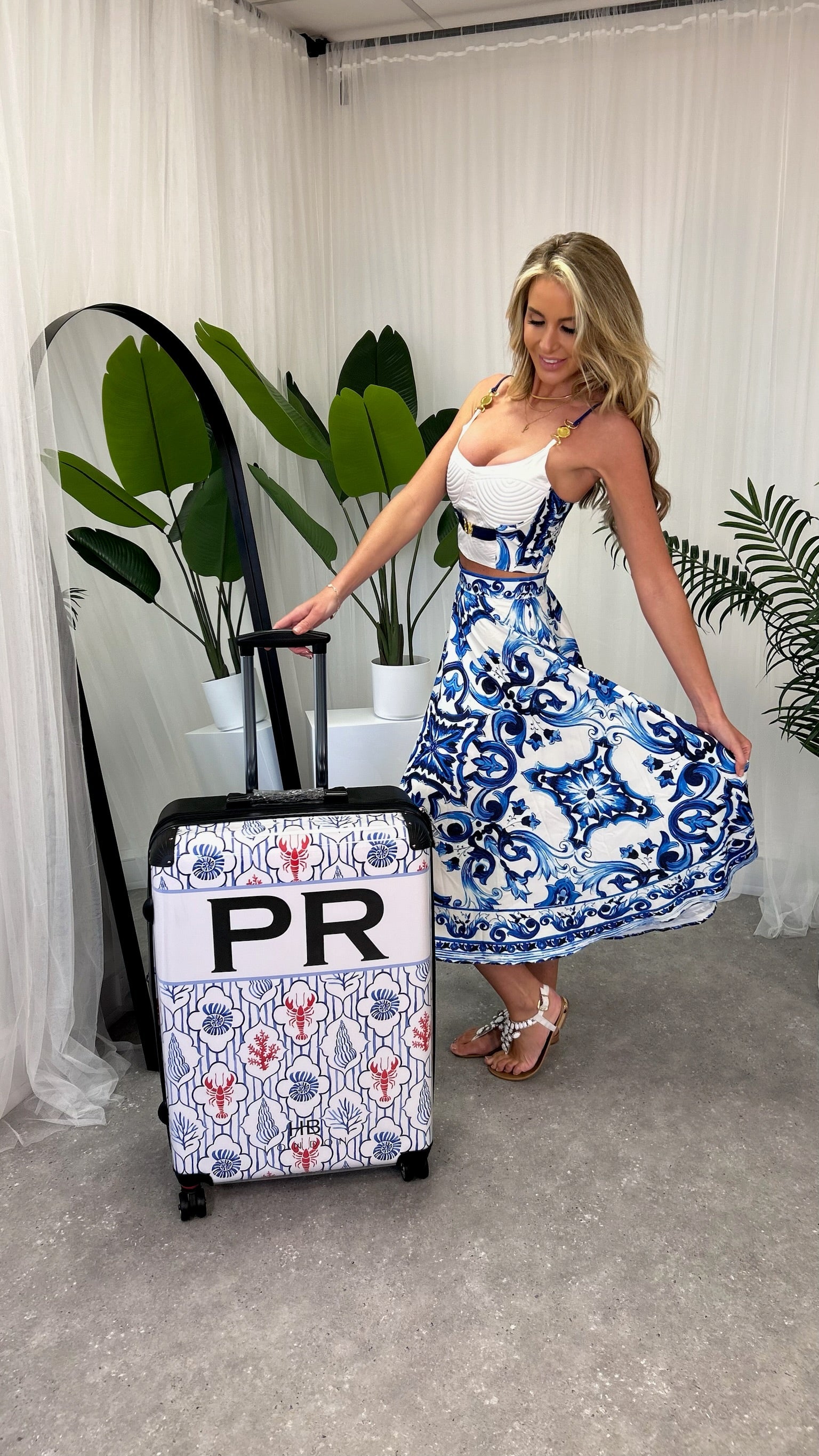 Model showcasing the Penelope 2-Piece Bralette Crop Top and Maxi Skirt Set in a scenic summer setting, embodying elegance.