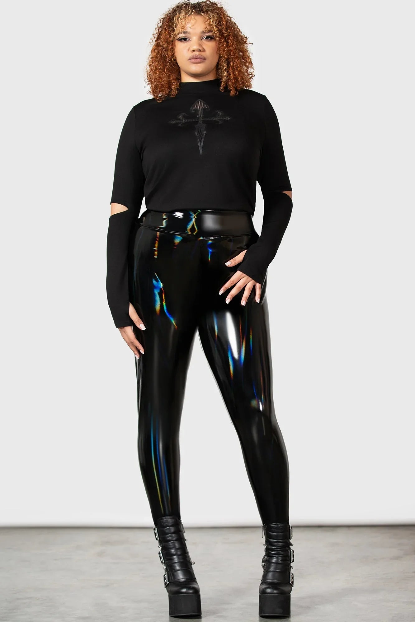 Flat lay of Killstar Darkwaves & Raves Hi-Shine PU Leggings showcasing their unique texture and vibrant rainbow finish, ideal for stylish night outings.