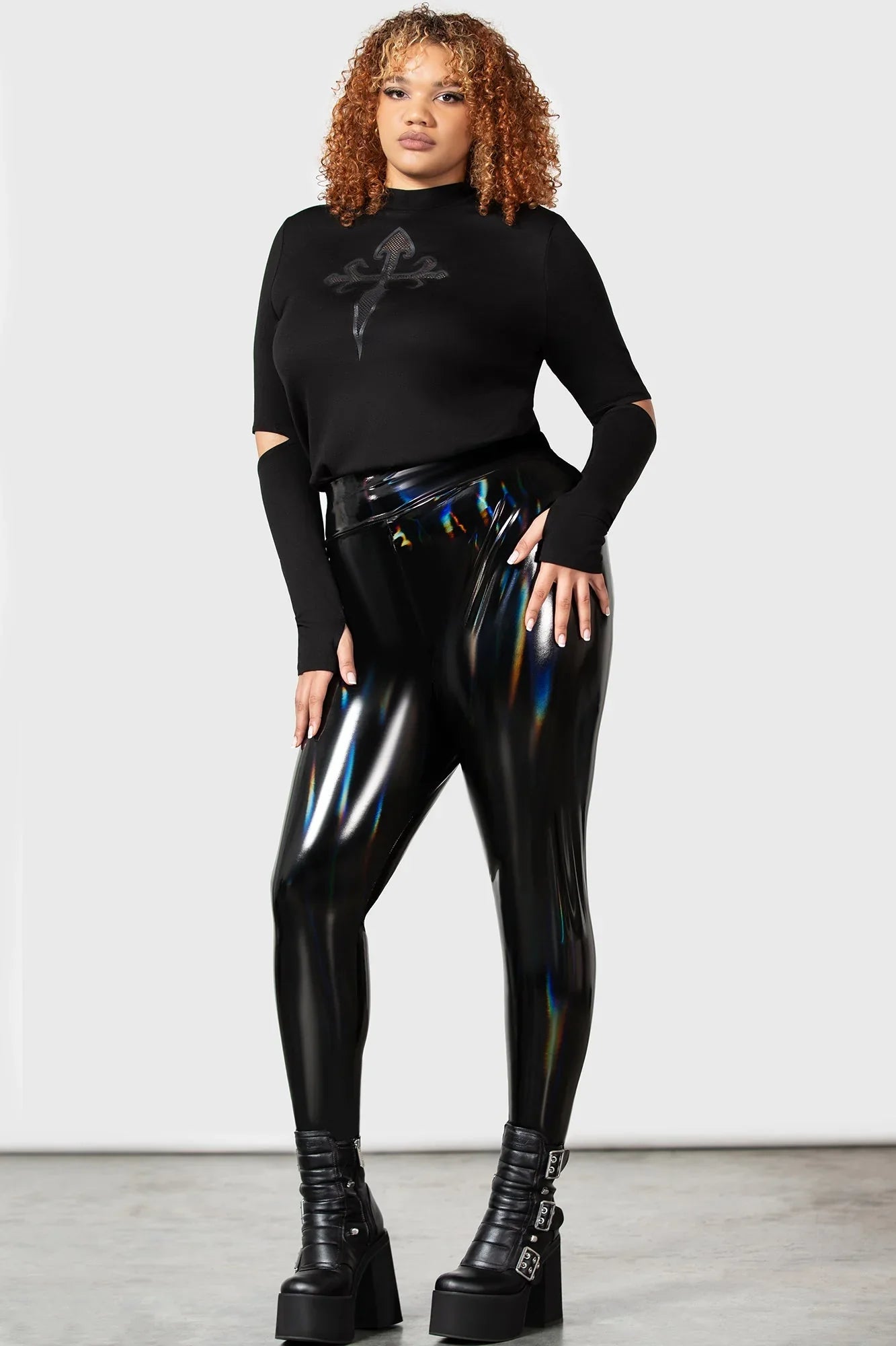 Luxury high-waisted Killstar Darkwaves & Raves Hi-Shine PU leggings featuring a stunning rainbow reflective finish, designed for a fitted silhouette and ultimate comfort, ideal for a chic goth club ensemble.
