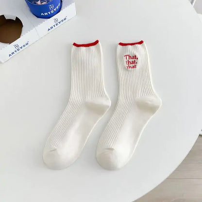 Stunning Elegant White Embroidered Socks for Women with a unique Japanese-style font design in vibrant red detail, elegantly presented on a tabletop for a luxurious touch.