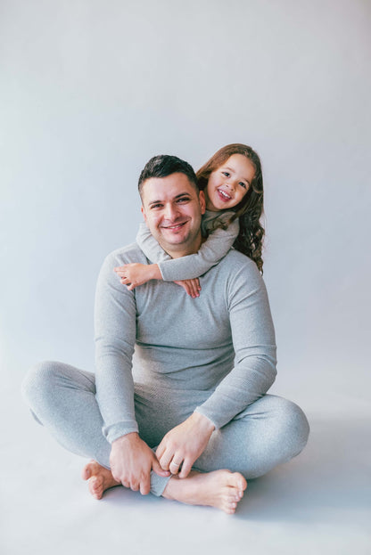 Cozy family wearing DreamBuy Dove Grey Matching Pyjamas, perfect for Christmas celebrations and family photo opportunities.