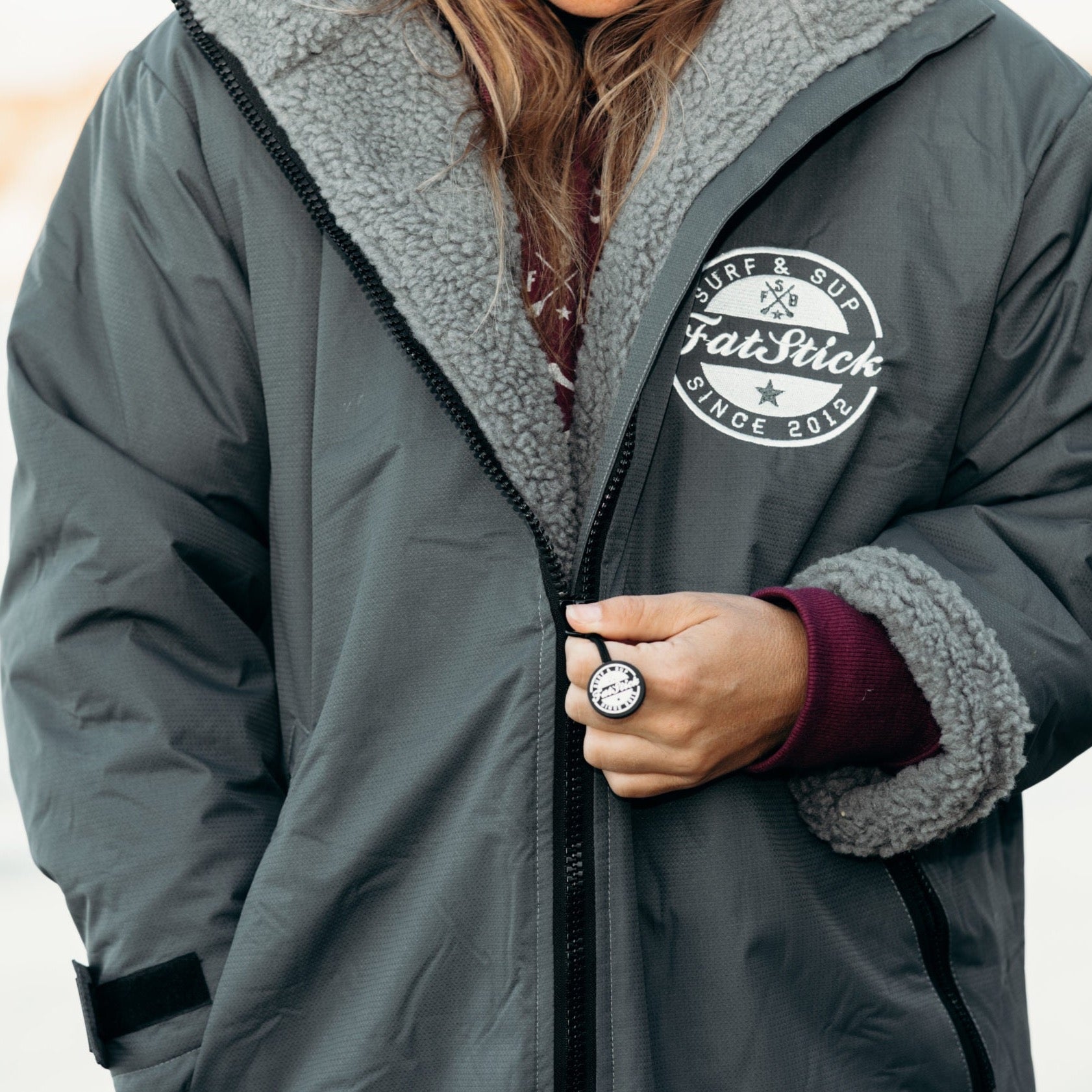 Elegant and functional features of the FatWrap changing robe, including deep zip pockets and adjustable cuffs, ideal for stylish water sports enthusiasts.