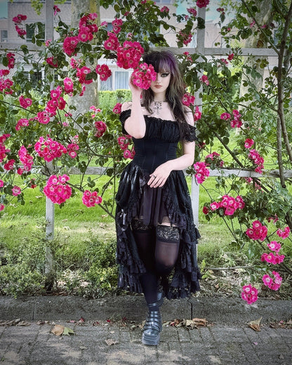 Back view of the Dark In Love Lilinoe Off Shoulder Dress displaying the intricate lace-up design, perfect for a luxurious evening look.