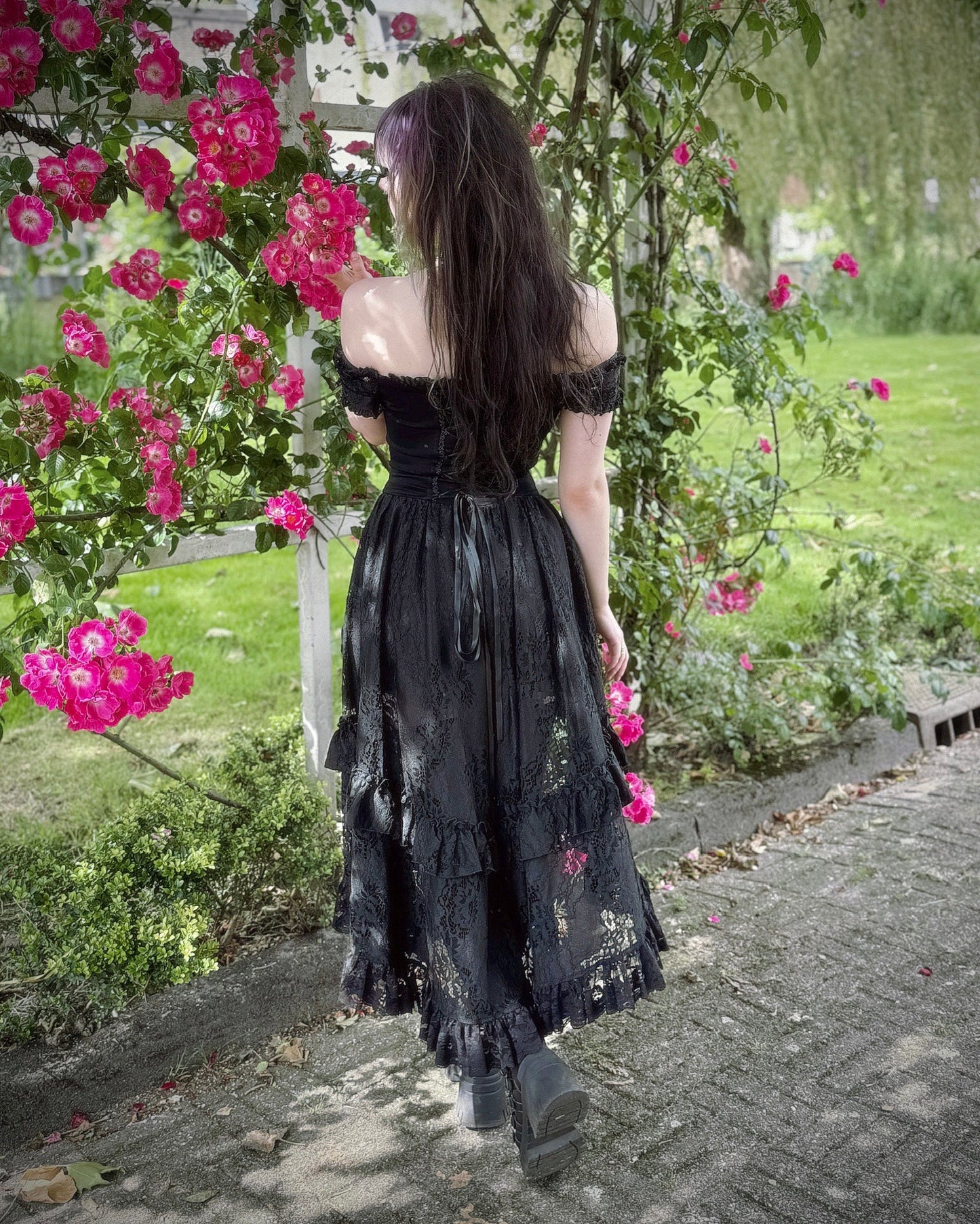 Model wearing the Dark In Love Lilinoe Off Shoulder Dress in a glamorous setting, embodying elegance and sophistication for evening wear.