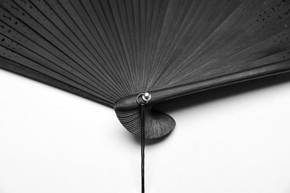 Punk Rave Delaney Hand Fan displayed elegantly, highlighting its unique skull charm and sophisticated craftsmanship.