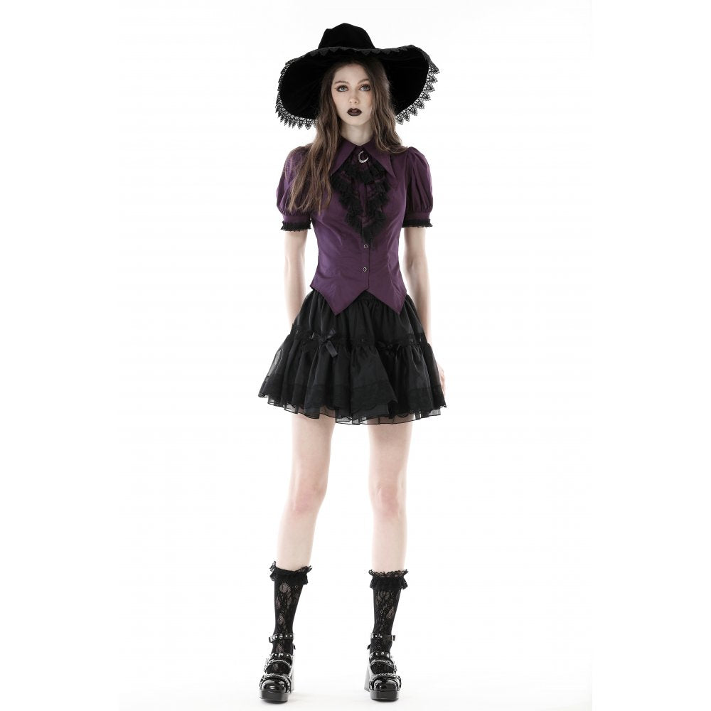 Close-up of Druantia Blouse neckline featuring crescent moon charm detail, highlighting luxurious deep purple cotton texture and stylish puff sleeves.