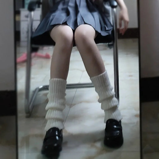 Luxury Long Socks Women's Leg Warmers paired with a grey pleated skirt and black loafers, creating a sophisticated winter look perfect for any occasion.