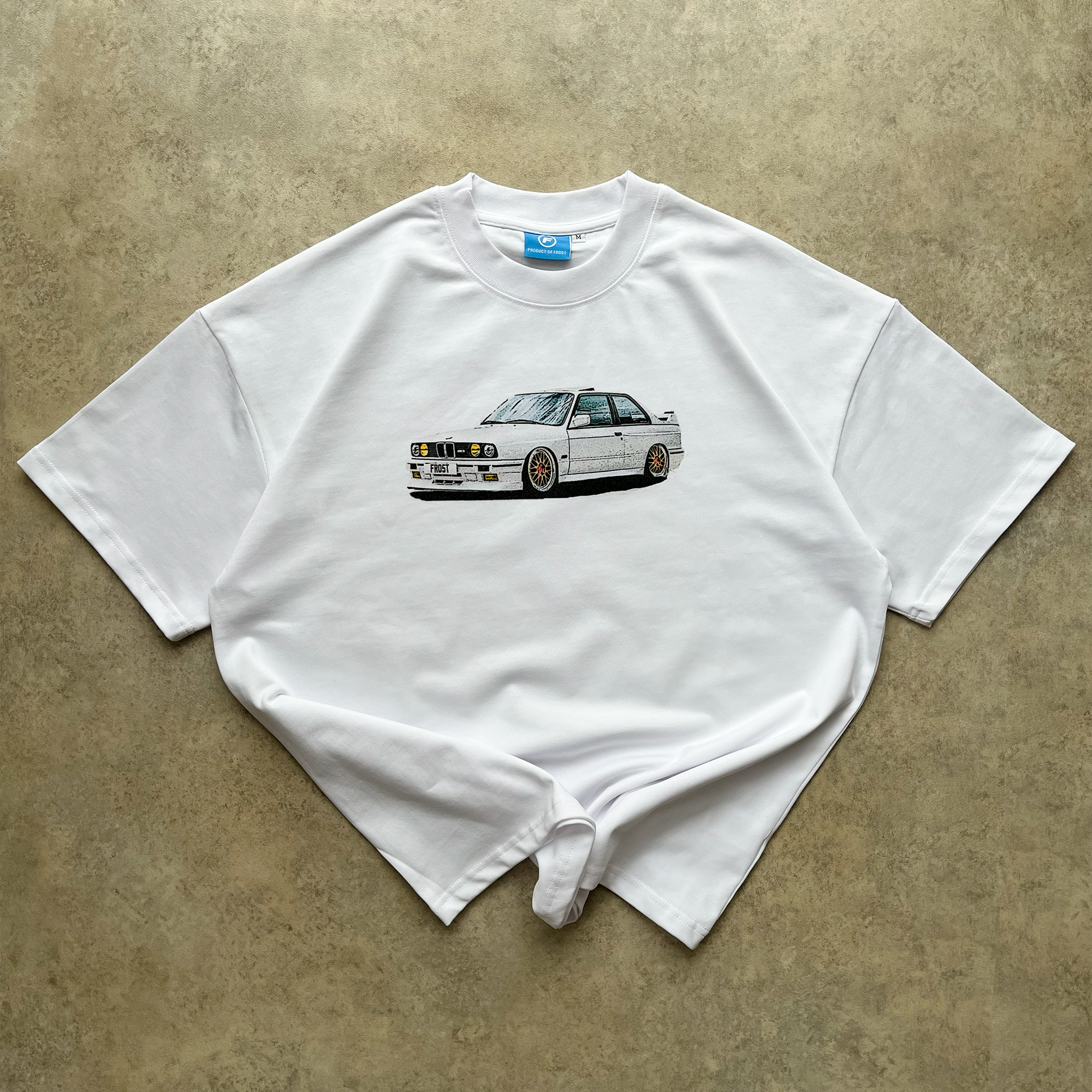 FROST Frost E30 Graphic Tee on model, styled with denim, illustrating the modern fit and versatility of this luxury streetwear piece.