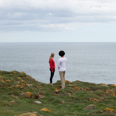 Close-up of the twin-needle stitching on the hem and cuffs of a luxury organic cotton long-sleeve tee, showcasing quality craftsmanship.