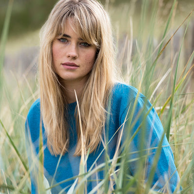 Trendy model wearing Earth Wardrobe's long sleeve set-in recycled sweatshirt, highlighting sustainable fashion with a chic style.