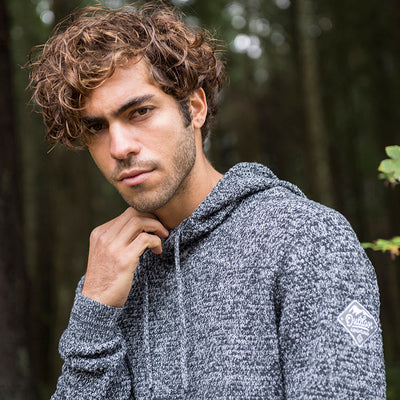 Stylish outdoor setting featuring the Iguazu chunky tuck stitch hoodie, an embodiment of sustainable luxury fashion.