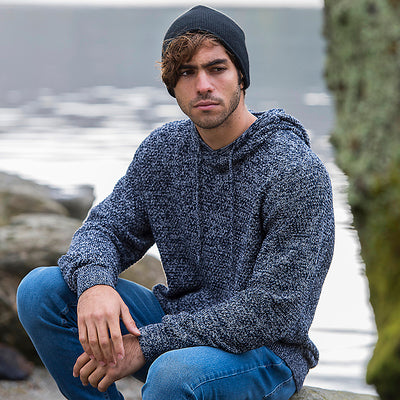 Elegant Iguazu Recycled Knitted Hoodie in a rugged design featuring chunky tuck stitch and luxurious drawcord hood, blending style and sustainability.