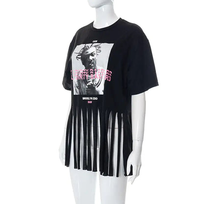 Side view of the Women's ODB Graphic Print Tassel Tee highlighting its eye-catching design and playful tassels, ideal for a trendy wardrobe.