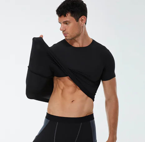 Luxury men's black compression training t-shirt worn during a workout, showcasing athletic physique and quick-dry fabric.