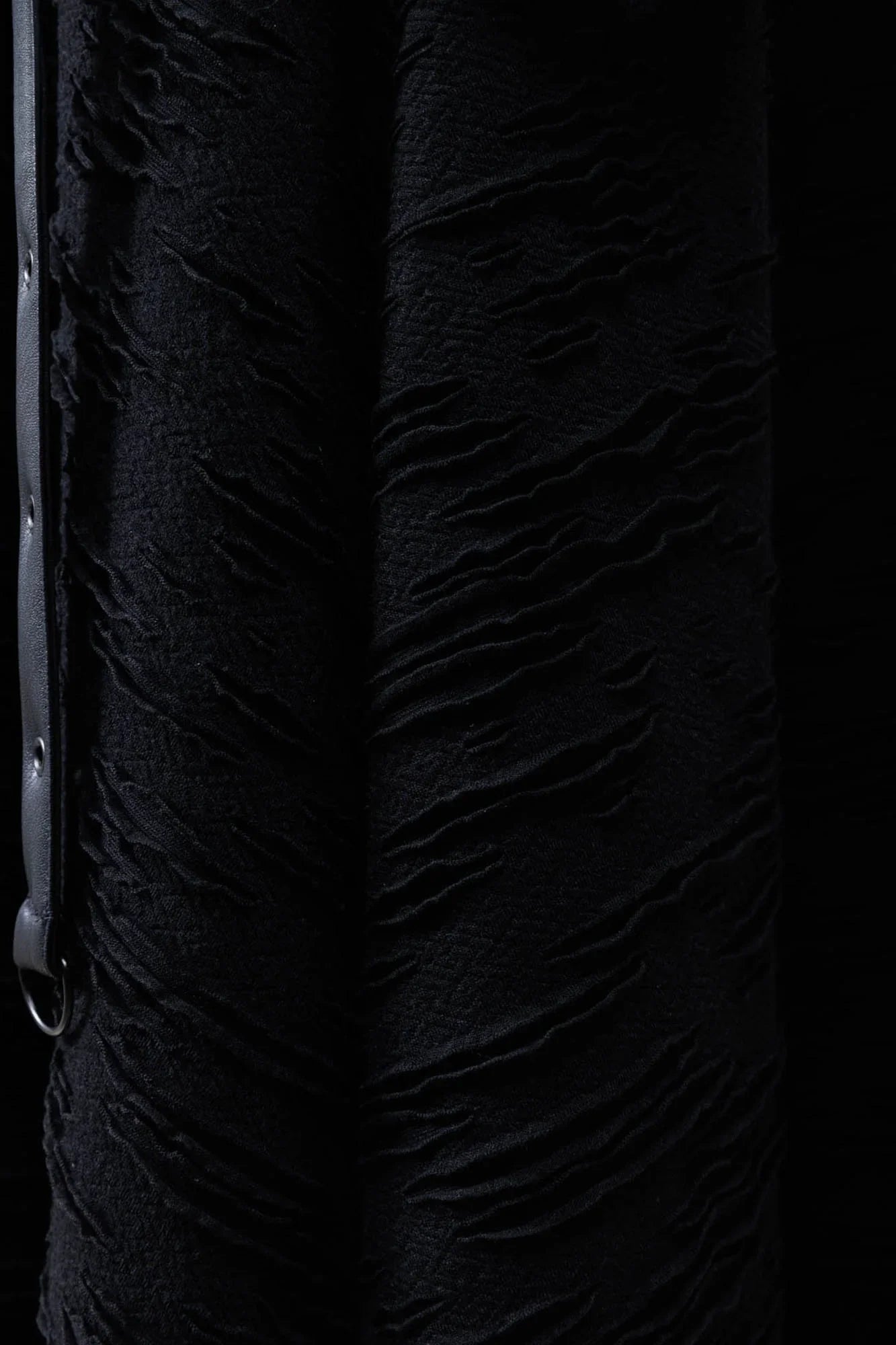 Close-up detail of the Killstar Gloomara Skirt's soft-stretch textured jersey fabric and black hardware straps, highlighting luxurious comfort and gothic elegance.