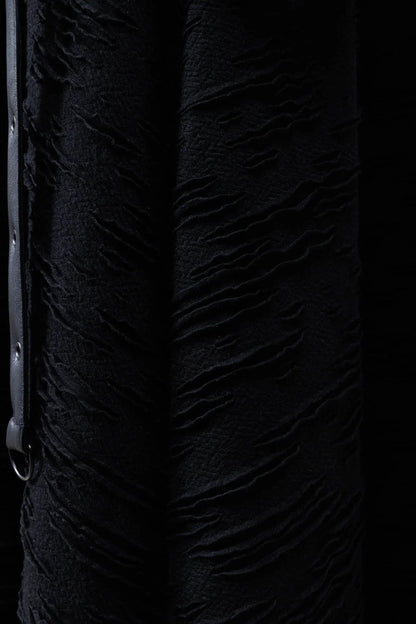 Close-up detail of the Killstar Gloomara Skirt's soft-stretch textured jersey fabric and black hardware straps, highlighting luxurious comfort and gothic elegance.