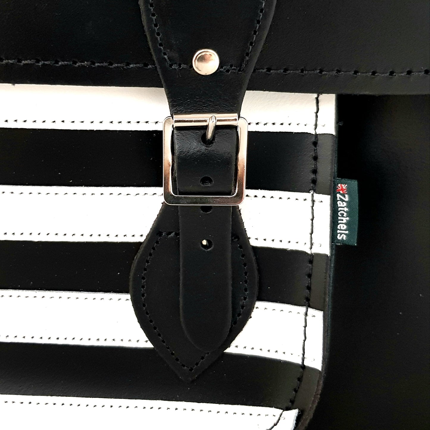 Close-up of Gothic Striped Leather Satchel's intricate cable stitching and premium quality leather, highlighting the luxurious details and durable silver nickel buckles.