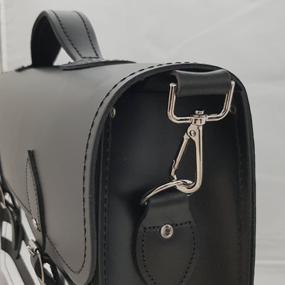 Stylish Gothic Striped Handmade Leather Satchel displayed with an adjustable strap, emphasising versatility and spaciousness for everyday essentials, perfect for both work and play.